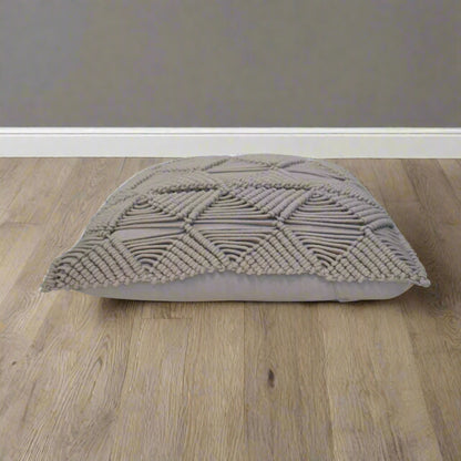 Side view of grey woven cushion with plump profile placed on a modern floor – Esmi cushion – Purple Flamingo UK