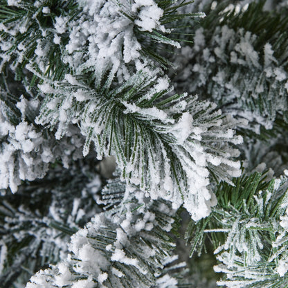 Detailed view of the lush, full frosted branches on an extra large artificial snowy spruce tree, showing the dense snow effect.
