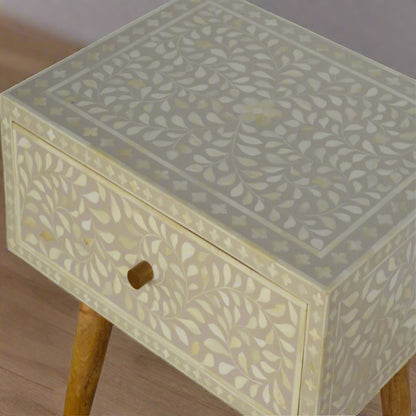 Elevated shot from the left side of the Floral Bone Inlay 1 Drawer Bedside Table in grey, showing its upper surface, front surface, and a section of the legs.