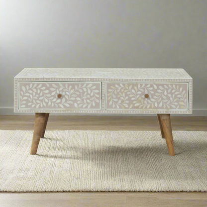 Front view of the Floral Bone Inlay Drawer Coffee Table in Taupe, showcasing its floral pattern drawers and oak-ish finish legs.