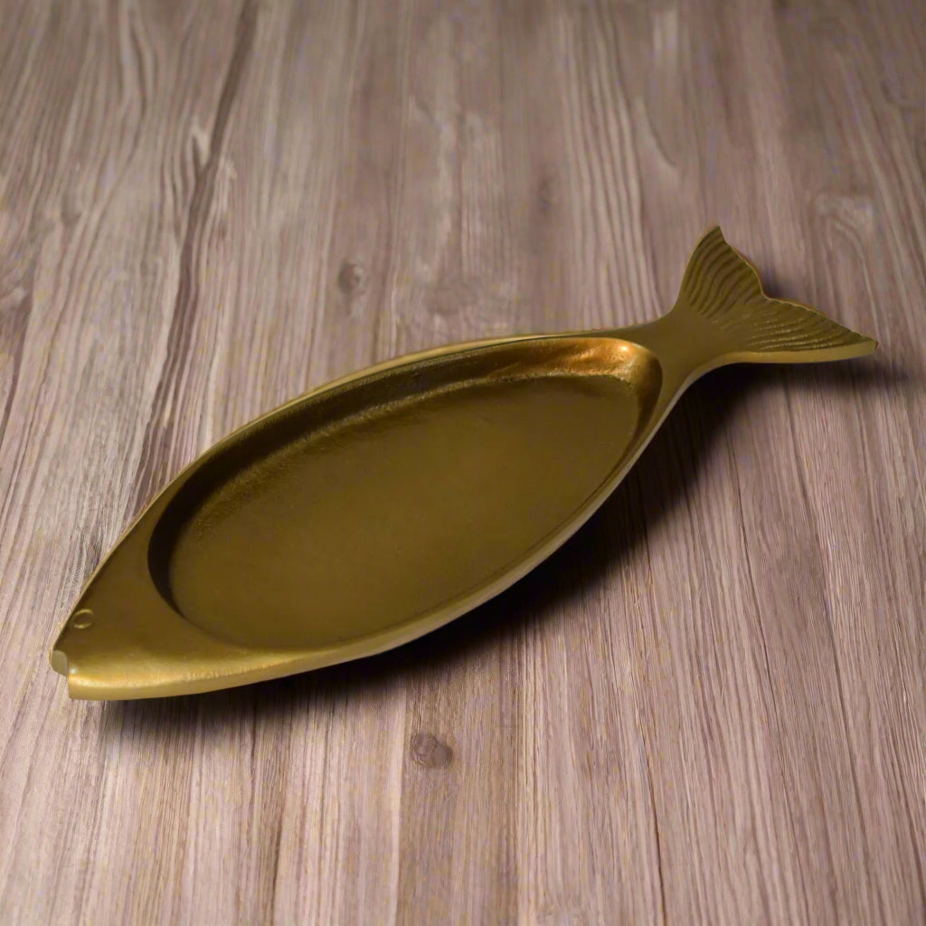 Full view of the fish-shaped brass tray with raised surface – a decorative home accent.