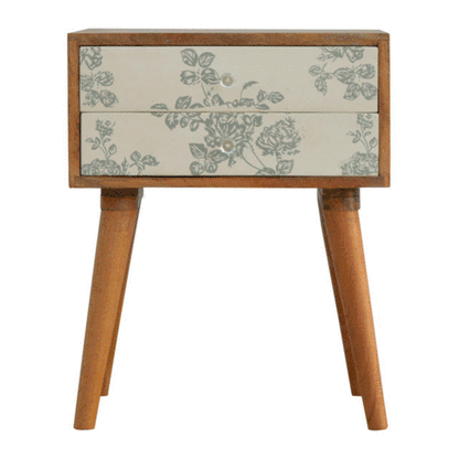 A rotating GIF showing the Green Floral Screen Printed 2 Drawer Bedside Table from multiple angles, highlighting its design, drawers, and legs.