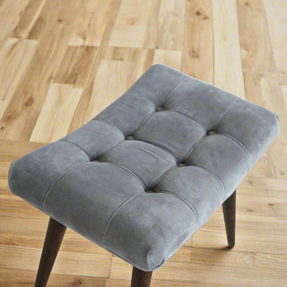 Top-down view of the grey velvet curve stool's seat, clearly showing the upholstered pattern.
