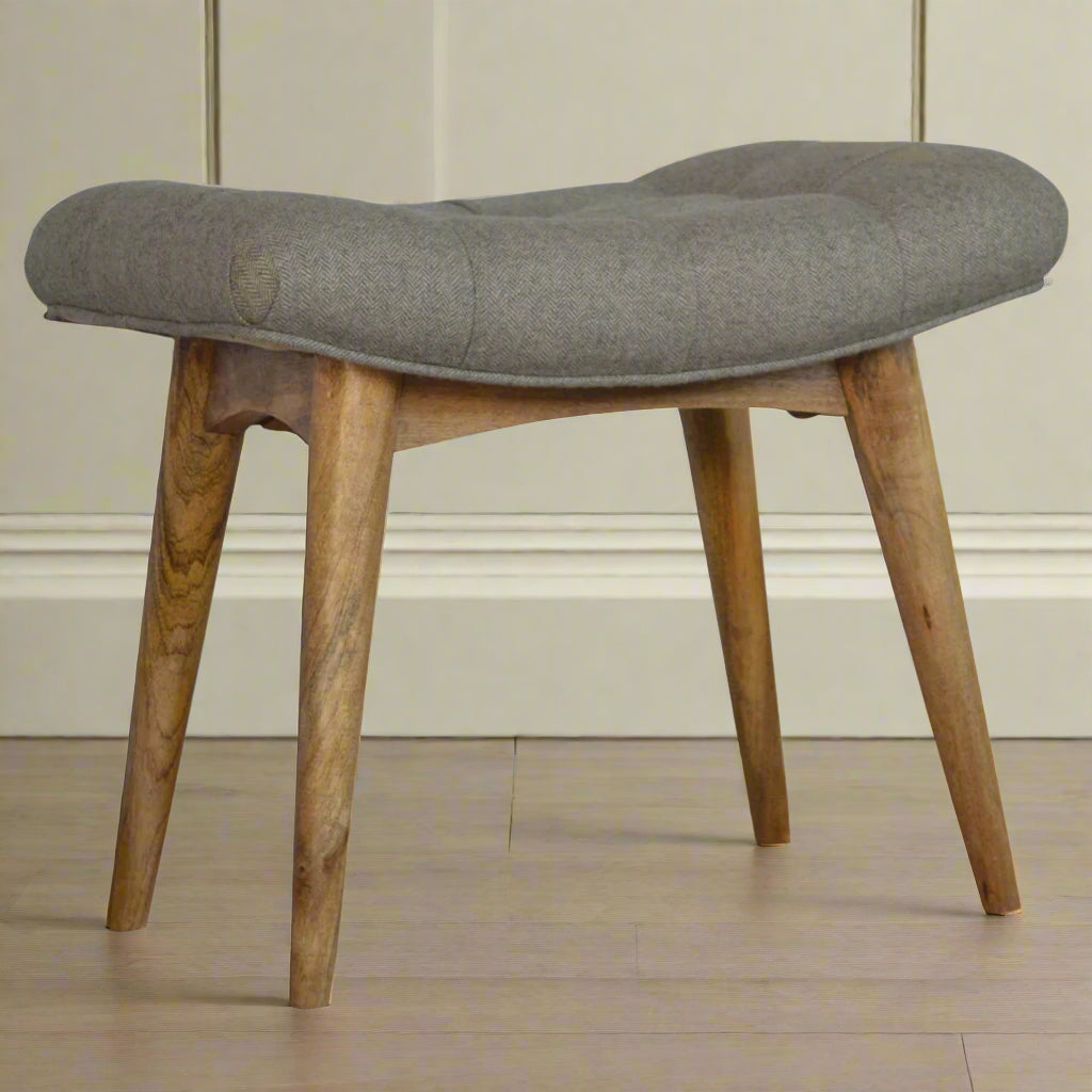 Front‑angled view of curve stool showing full seat and four oak‑ish legs
