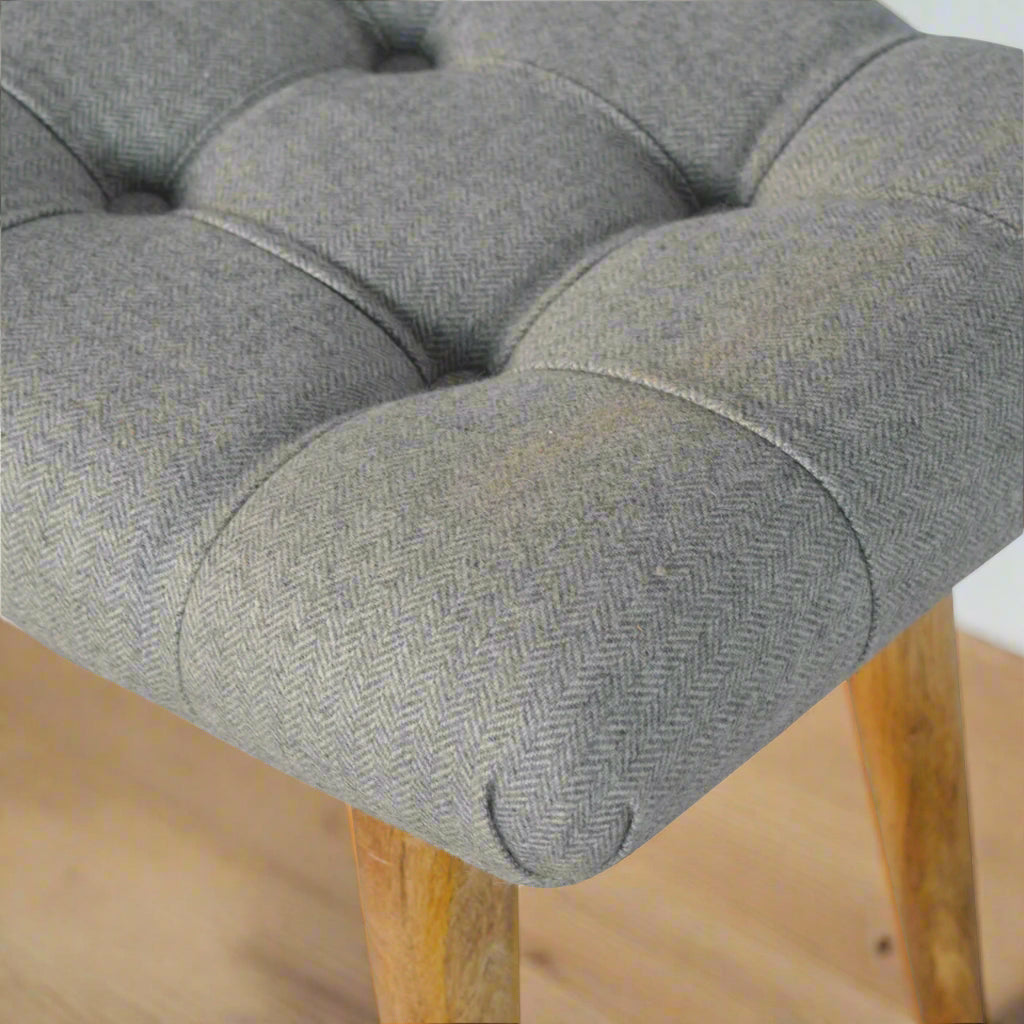 Close‑up of upholstered edge with neat piping and texture
