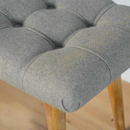 Close‑up of upholstered edge with neat piping and texture
