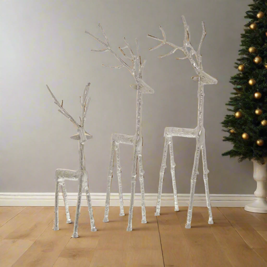 Three differently sized majestic stags sculpted beautfully in metal, grouped together in an eye-catching display. Multi-buy discount available at Purple Flamingo UK.
