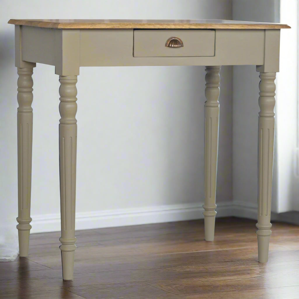 Front angled view of the Hand Painted Desk, showcasing its hand-carved flute legs and the central drawer with a French grey base.