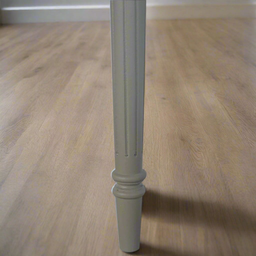 Close-up focus on the hand-carved flute legs of the Hand Painted Desk, emphasizing their vintage French style.