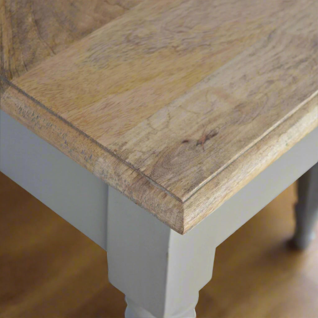 Top-down view of the right edge of the Hand Painted Desk, highlighting the wood grain on the stained oak-ish top surface and the start of the legs.