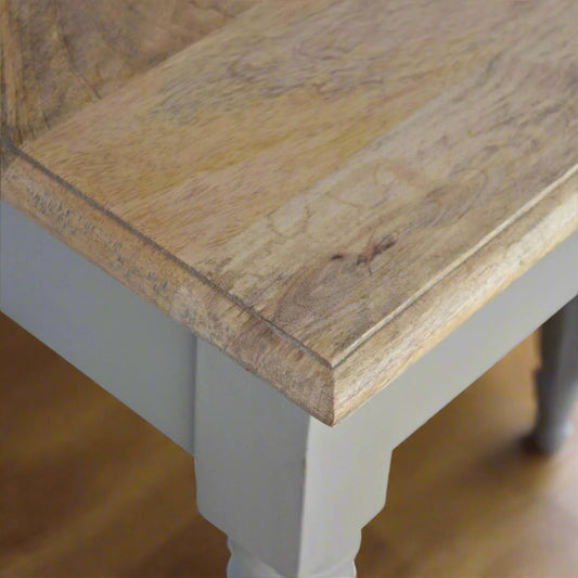 Top-down view of the right edge of the Hand Painted Desk, highlighting the wood grain on the stained oak-ish top surface and the start of the legs.