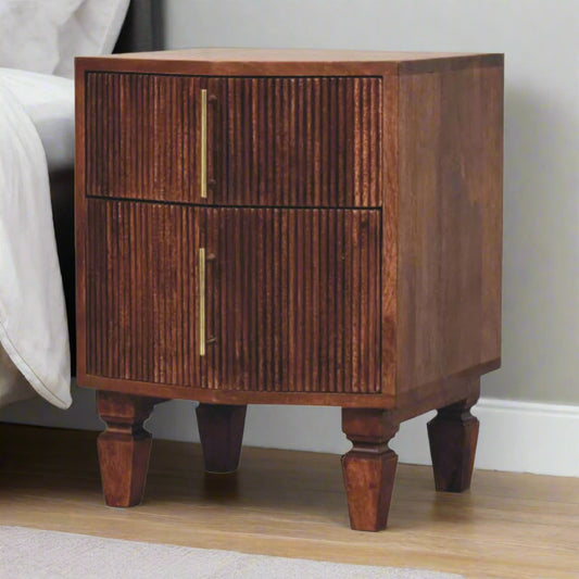 Front angled view of the Harper bedside tablet, with Amber Oak finish, placed next to a bed in a contemporary bedroom setting.
