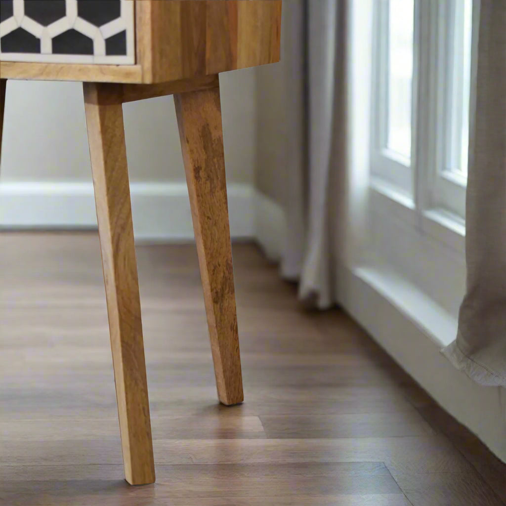 Side view close-up of the Honeycomb Bone Inlay Tapered Bedside Table, specifically focusing on its stylish and slender tapered legs.