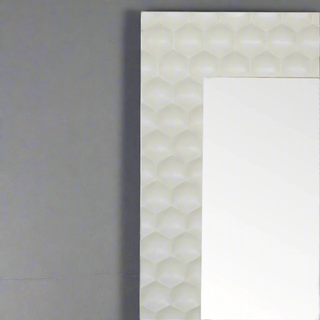 Close-up of the top right section of the Honeycomb Mirror's hand-carved, white honeycomb pattern frame.