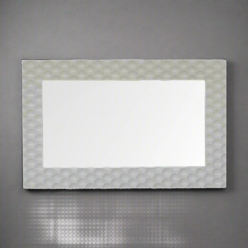Honeycomb Mirror mounted horizontally on a grey wall, showcasing its versatility for different orientations.