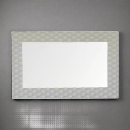 Honeycomb Mirror mounted horizontally on a grey wall, showcasing its versatility for different orientations.