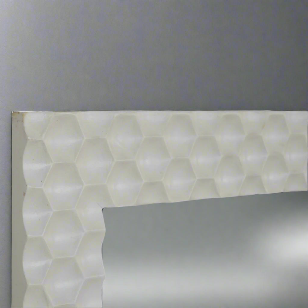 Extreme zoom-in on the right upper edge of the Honeycomb Mirror, highlighting the intricate hand-carved honeycomb pattern on the frame.