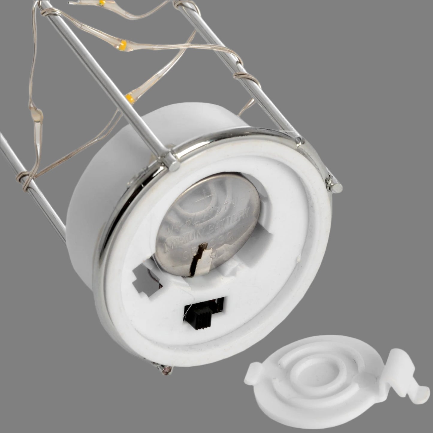 Open battery compartment on the lantern base, showing installed CR2032 battery.