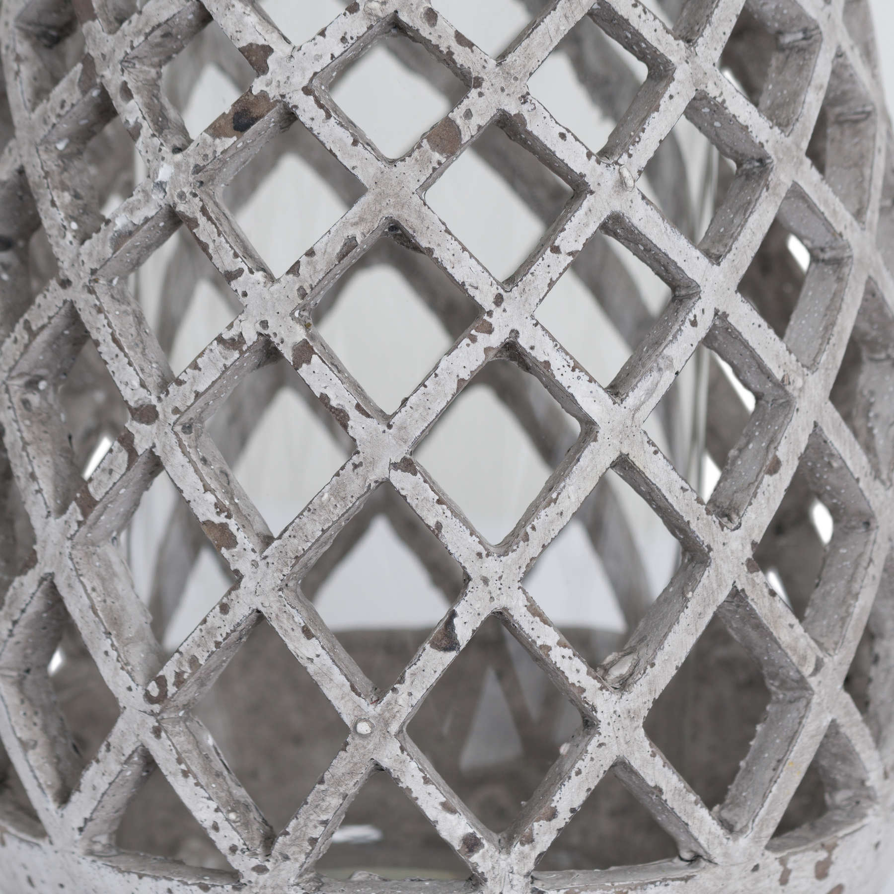 Close-up of the ceramic lantern's lattice pattern showing the natural stone finish.