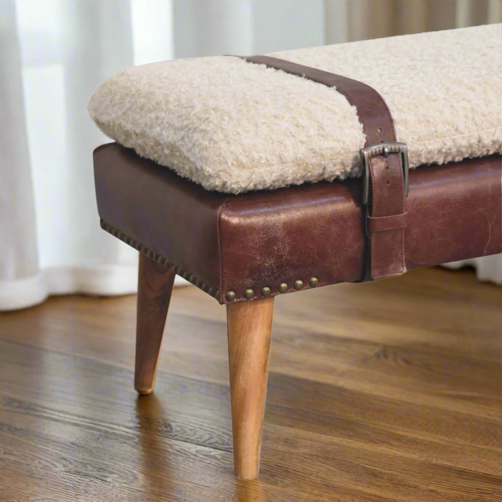 Close-up showing belt securing the cotton bouclé fabric on the brown bench