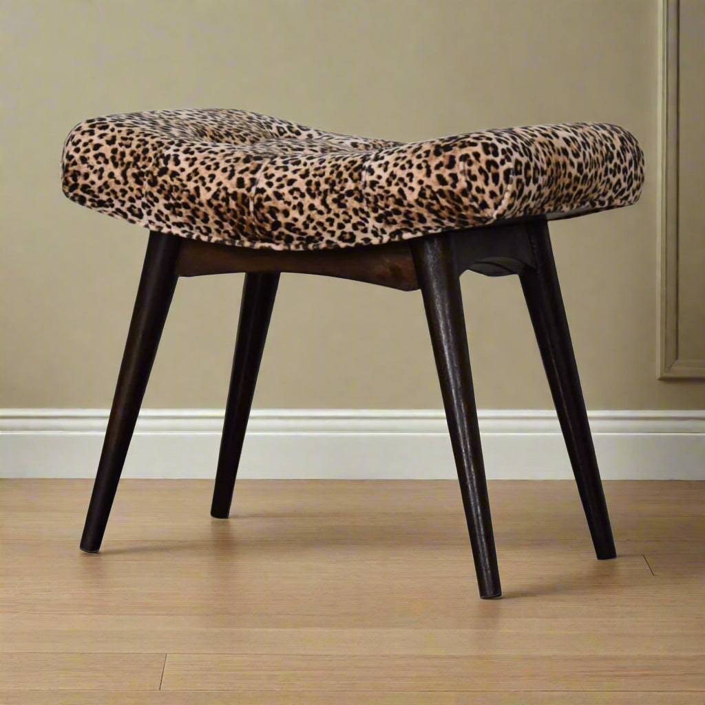 Angled view of the Leopard Print Curve Stool, displaying its upholstered seat and all four Nordic style legs.