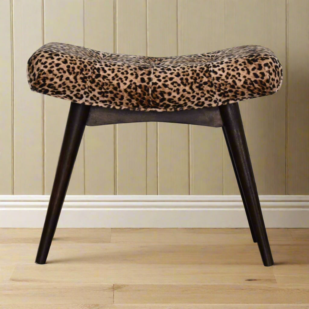 Front view of the Leopard Print Curve Stool, showcasing its distinctive upholstered seat and front legs.