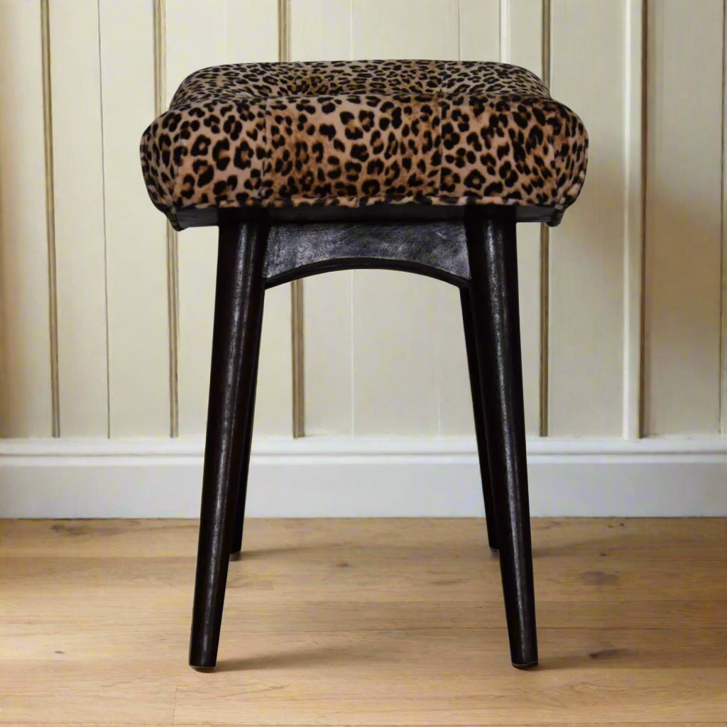 Side view of the Leopard Print Curve Stool, illustrating its curved silhouette and overall dimensions.