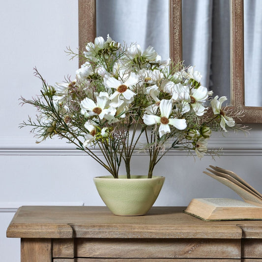 Front view of the light green flower frog vase styled with flowers.