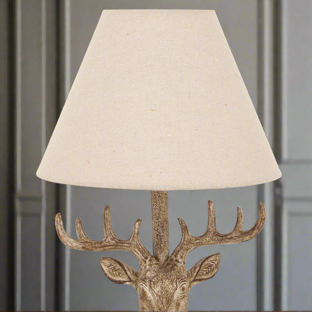 Detail of linen shade and top section of stag head table lamp, highlighting refined rustic style from Purple Flamingo UK.