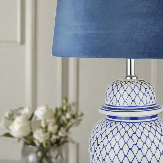 Close-up of the velvet lampshade and top section of the ceramic ginger jar base with plant on the side.