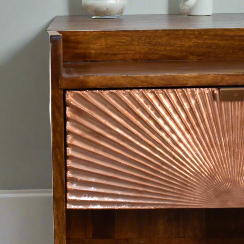 A close-up view of the copper plated drawer and a section of the upper surface of the bedside table, with the pull-out handle clearly visible.