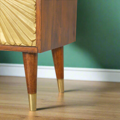 Close-up of the tapered wooden legs of the Manila Gold bedside table, highlighting the stylish brass cap feet and chestnut finish.