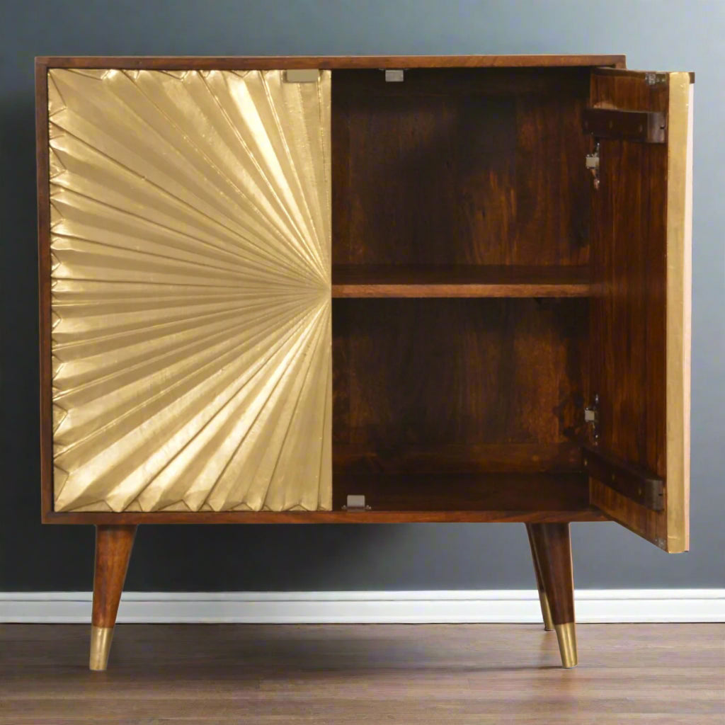 Manila Gold Cupboard with one of its brass-plated sunburst door open, revealing ample interior storage space and the solid mango wood construction.