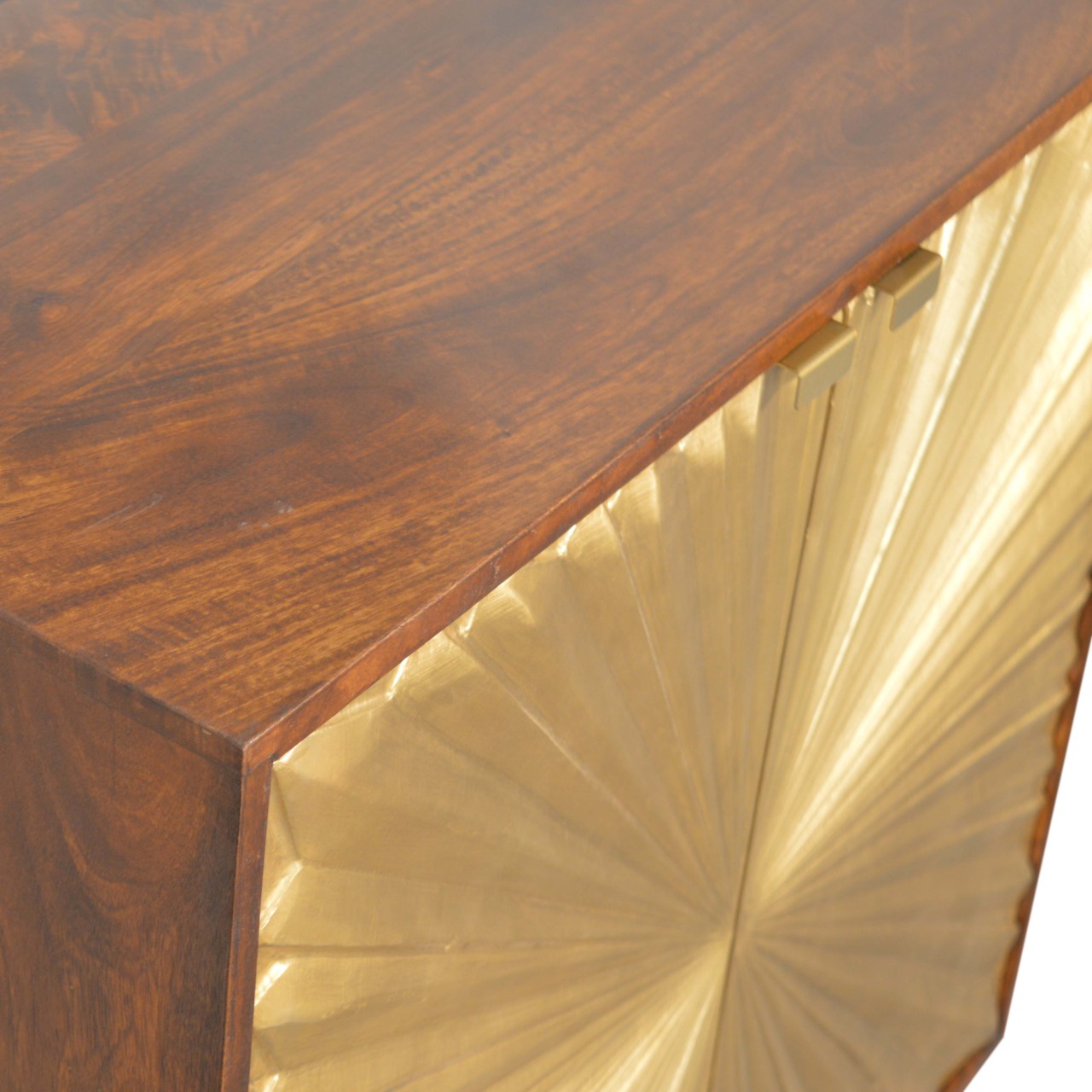 Close-up of the Manila Gold Cupboard's top surface in a rich chestnut finish, highlighting the textured brass-plated door with its unique sunburst design, crafted from solid mango wood