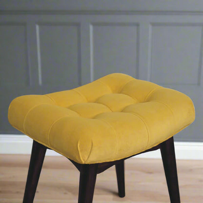 Top-down view of the mini mustard velvet curve stool, clearly displaying the elegant deep button pattern on its upholstered seat.