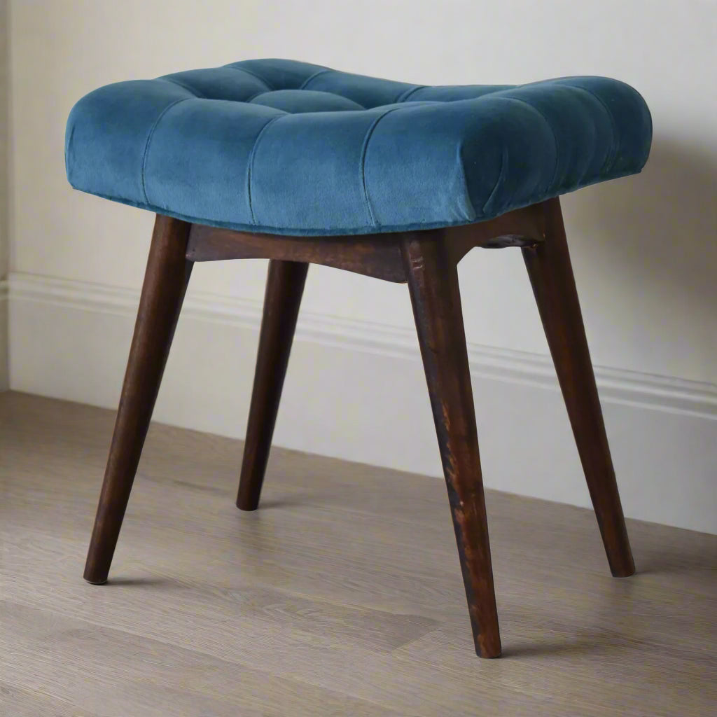Angled view of the mini teal velvet curve bench, displaying its profile from the side and all four solid wood feet.