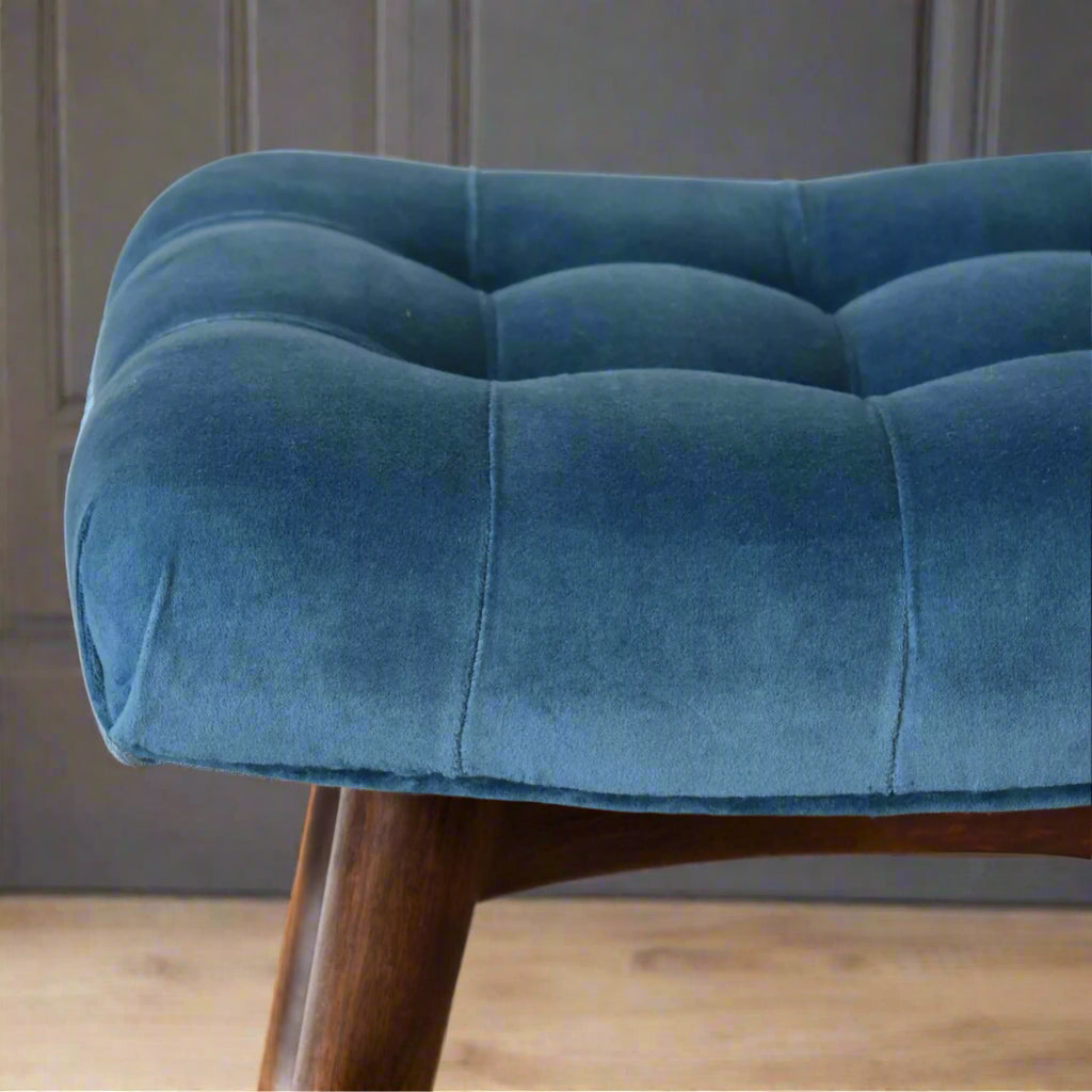 Close front view of the right edge of the mini teal velvet curve bench seat, highlighting the luxurious upholstered velvet fabric and the elegant deep button pattern.