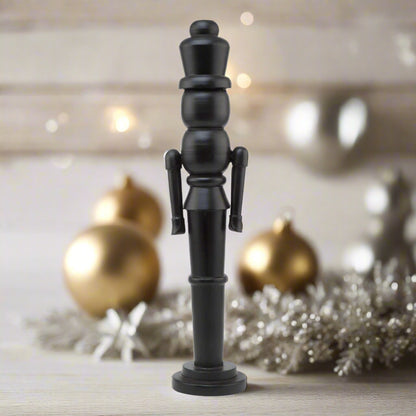 A tall, sleek minimalist black wooden large nutcracker decoration with a modern, clean-lined silhouette, perfect for contemporary Christmas decor.