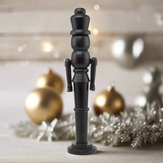 A tall, sleek minimalist black wooden large nutcracker decoration with a modern, clean-lined silhouette, perfect for contemporary Christmas decor.