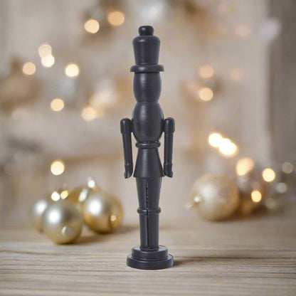 A tall, sleek minimalist black wooden nutcracker decoration with a refined silhouette, perfect for contemporary Christmas decor and Nordic-inspired displays.