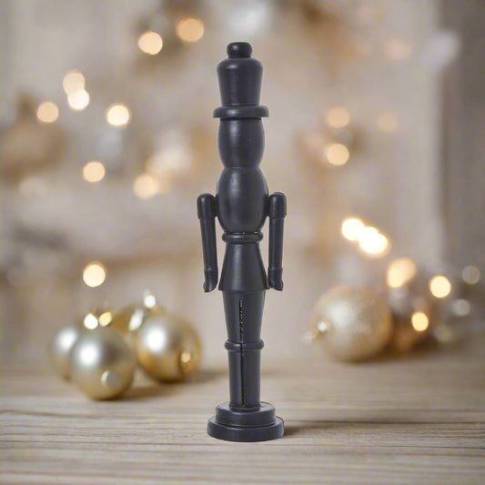 A tall, sleek minimalist black wooden nutcracker decoration with a refined silhouette, perfect for contemporary Christmas decor and Nordic-inspired displays.