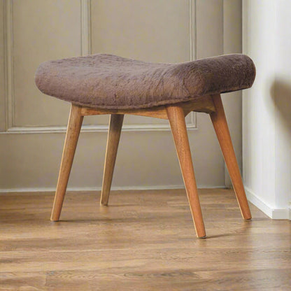 Angled view of the Mocha Faux Fur Curve Stool, displaying its upholstered seat and all four elegant Nordic style legs.