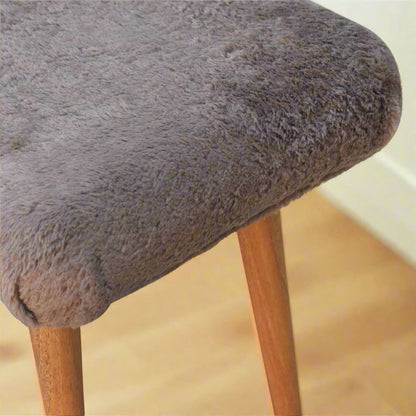 Close view of the edge of the Mocha Faux Fur Curve Stool, emphasizing the soft and luxurious faux fur finish.