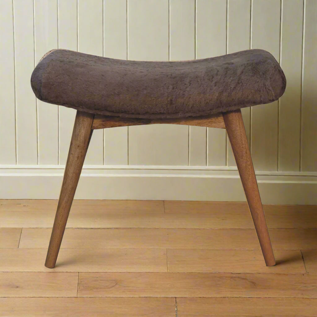 Front view of the Mocha Faux Fur Curve Stool, showcasing its cozy faux fur upholstery and front Nordic style legs.