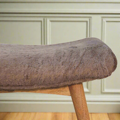 Close-up focus on the left edge of the Mocha Faux Fur Curve Stool, highlighting the plush faux fur fabric.