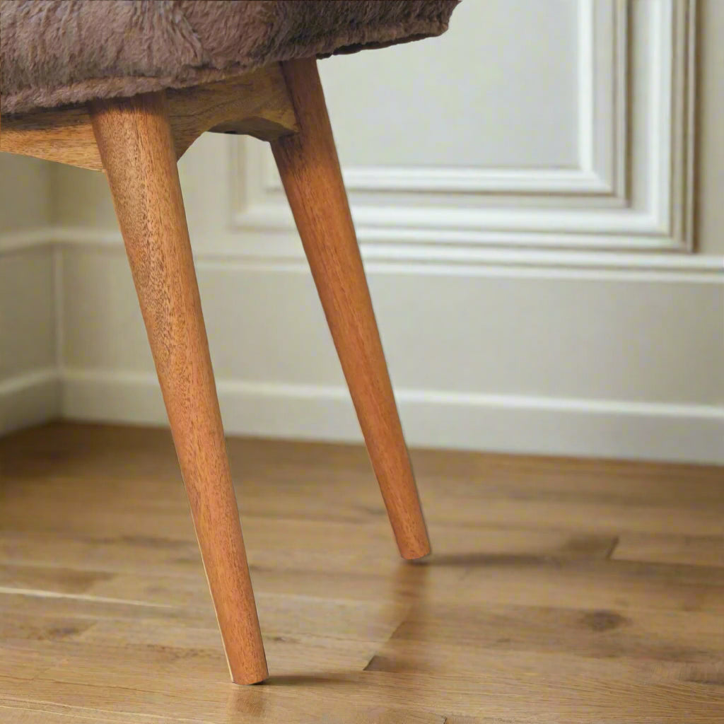 Close view of the Nordic style legs of the Mocha Faux Fur Curve Stool, showcasing their design and oak-ish finish.