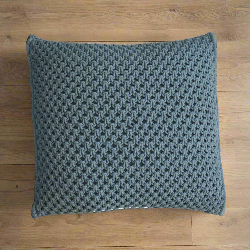 Aerial view of a single Myra blue cushion, highlighting its intricate woven design and texture.