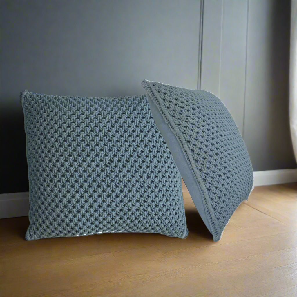  Set of two Myra blue cushions, one upright and one leaning, clearly displaying the visible woven pattern and plump filling.