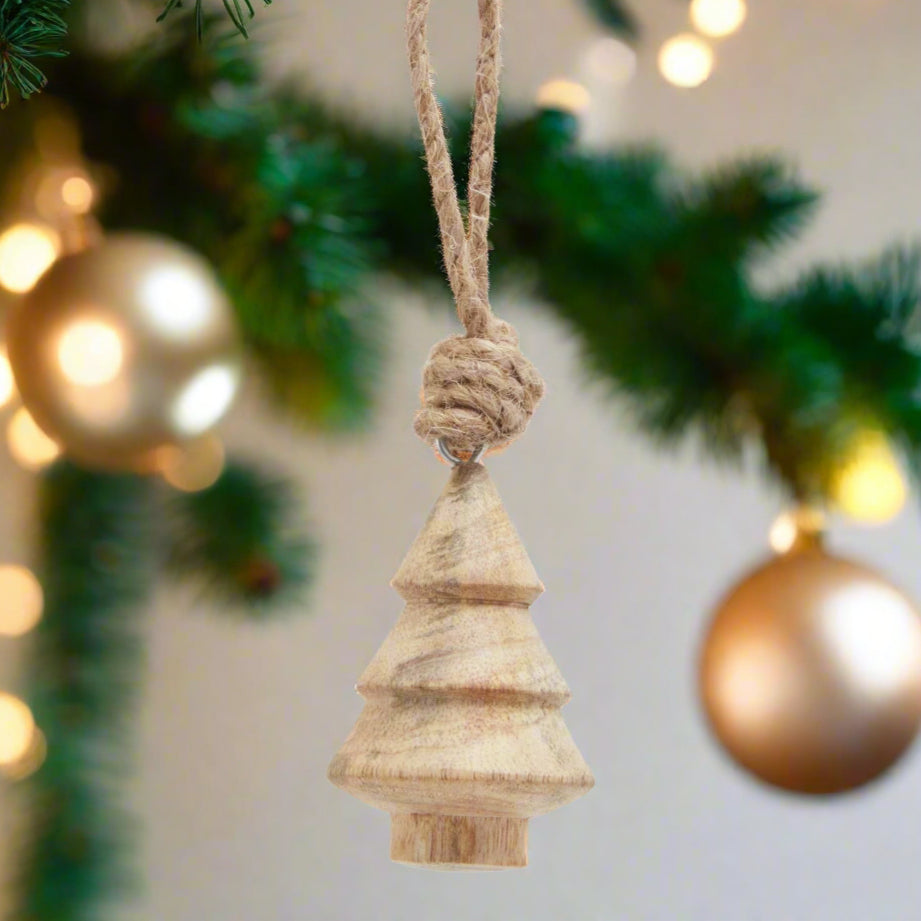 A natural hand-turned wooden Christmas tree bauble with a rustic rope hanger, showcasing unique wood grain and a classic tree shape, perfect for festive decor.