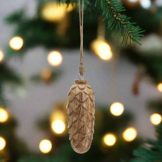 A large natural wooden pine cone bauble with a rustic finish and intricate details, perfect for woodland-themed Christmas tree decorations or festive displays.